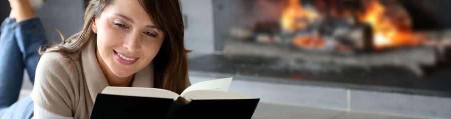 Women reading in front of fireplace