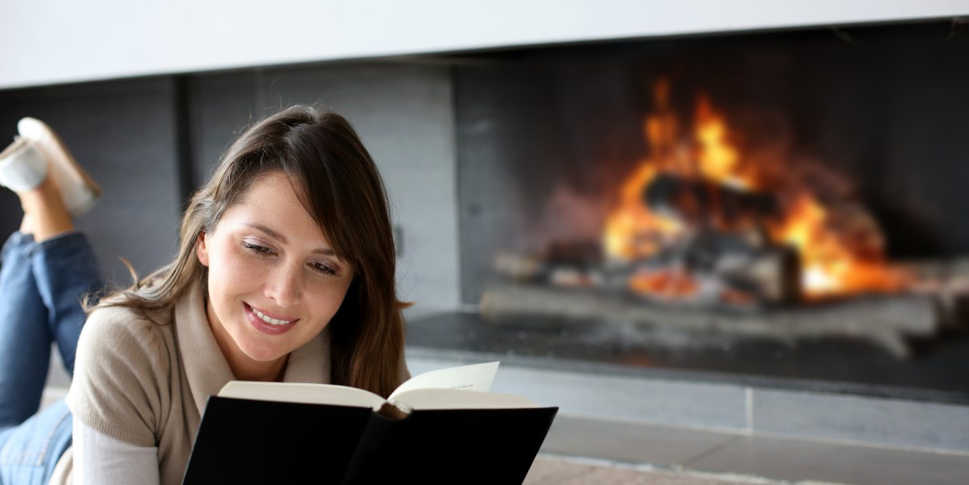 Women reading in front of fireplace