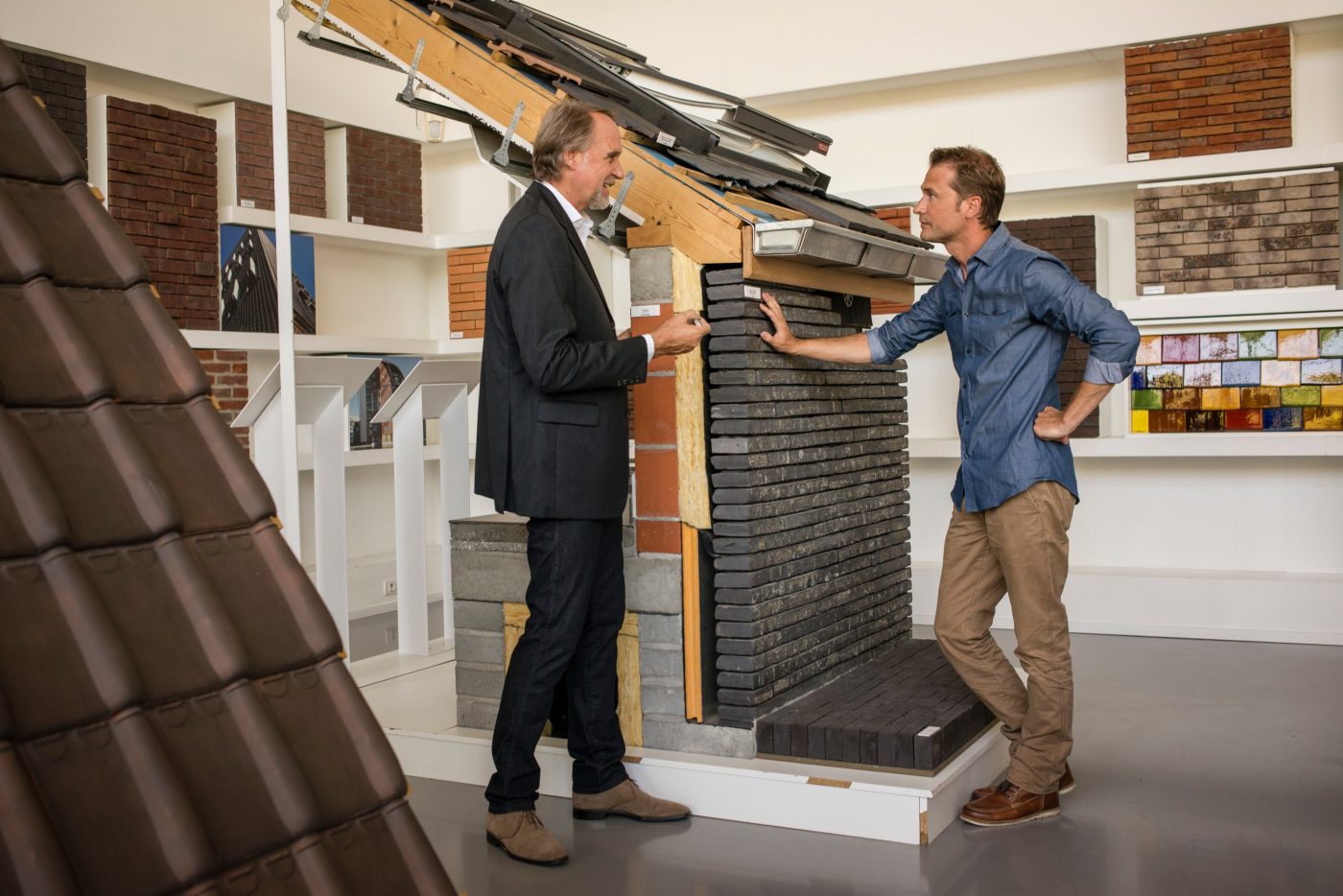 Man with architect standing by a mock-up in showroom Londerzeel