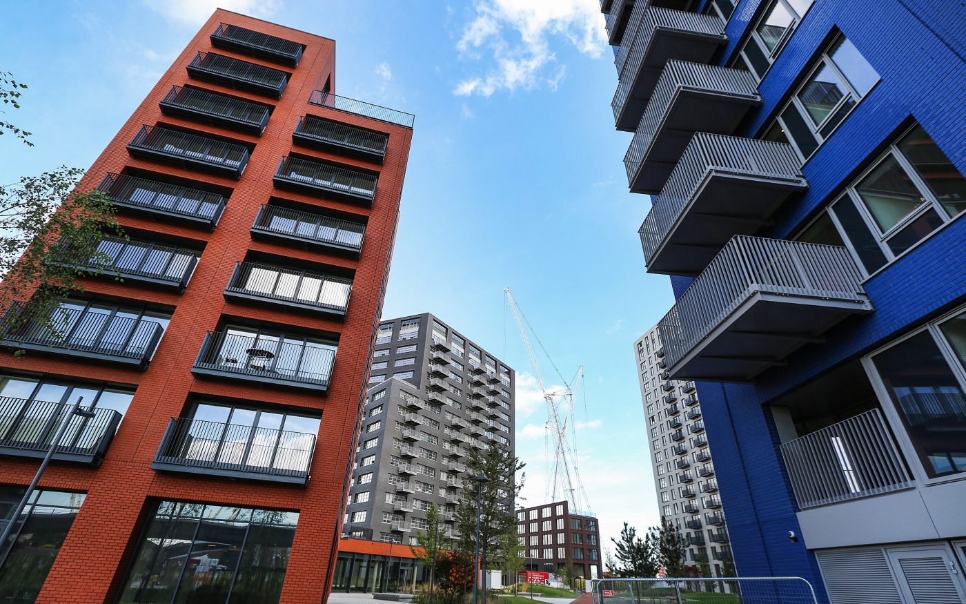 Bright red and blue glazed brick facades on apartment buildings