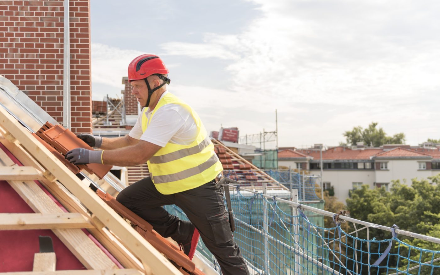 Urban roofers roofer laying roof tiles construction worker wearing hard hat