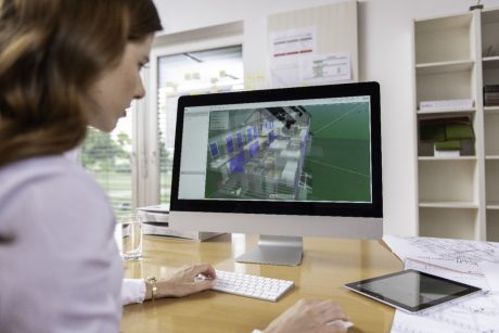 Female project manager at office desk working with BIM