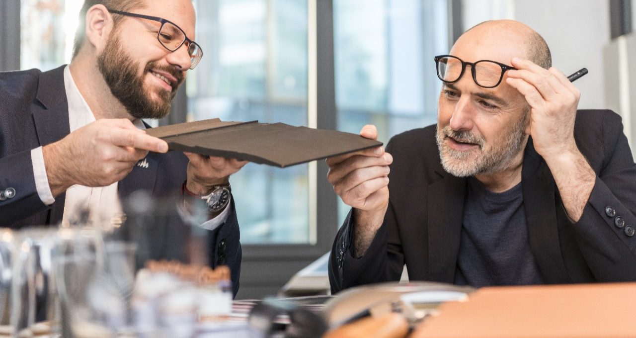 Architect inspecting clay roof or facade tile (Bellus, Facatile) at a meeting room with Wienerberger employee, Fast Forward Commercial Excellence