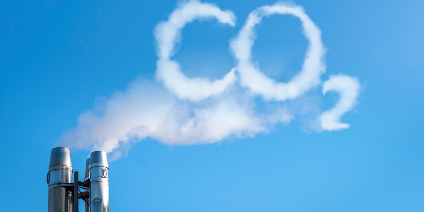 Smoke of chimney writing CO2 in the sky
